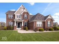Beautiful two-story brick home features a manicured lawn and inviting entrance, showcasing classic architectural details at 1243 Colinbrook Cir, Greenwood, IN 46143