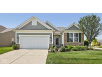 Charming home with landscaped front yard, two-car garage, and a welcoming entrance at 12907 Shiraz Ln, Fishers, IN 46037