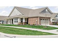 Charming home with a brick facade, covered porch, and well-manicured lawn at 17302 Graley Pl, Westfield, IN 46074