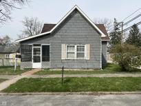 Charming home featuring a covered porch entry and classic architectural details at 214 S 10Th St, Elwood, IN 46036