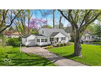 Charming home with a well-manicured lawn, attached garage, and inviting curb appeal at 2204 Pamela Dr, Indianapolis, IN 46220