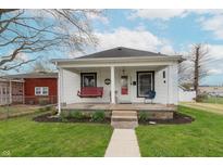 Charming single-story home featuring a covered front porch with a swing, walkway, and well-maintained lawn at 282 N Mapleton St, Columbus, IN 47201