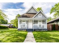 Charming home featuring a covered front porch, well-maintained lawn, and classic architectural details at 3031 Nowland Ave, Indianapolis, IN 46201