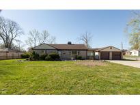 Charming single-story home with a well-maintained lawn and attached two-car garage at 3255 W 30Th St, Indianapolis, IN 46222