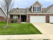 Inviting single-Gathering home featuring an attached two-car garage and well-maintained lawn in a suburban neighborhood at 4327 Switchgrass Way, Indianapolis, IN 46237