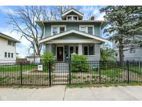 Charming two-story home with a well-maintained lawn and welcoming front porch at 433 Eastern Ave, Indianapolis, IN 46201
