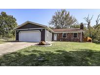 Charming one-story home with brick and siding and attached garage, set on a well-maintained lawn under a clear blue sky at 4421 Greenmeadow Ct, Indianapolis, IN 46235
