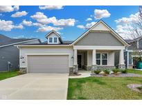 Charming single-Gathering home featuring a gray and beige exterior, a two-car garage, and a well-manicured lawn at 5309 Spyglass Dr, Whitestown, IN 46075