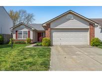 Charming single-story home featuring a two-car garage and well-maintained front yard at 7048 Tassel Meadow Dr, Indianapolis, IN 46217