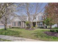 Charming two-story home featuring a combination of brick and siding, complemented by a well-manicured lawn and mature trees at 16994 Folly Brook Rd, Noblesville, IN 46060