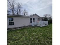 Modest single-story home with a small porch and vinyl siding at 1704 E Kirk St, Muncie, IN 47303