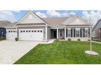 Charming single-story home featuring a manicured lawn, a two-car garage, and a welcoming entryway at 19283 Donelson Ln, Westfield, IN 46062