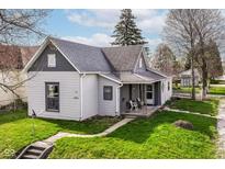 Charming home with a well-maintained lawn and a cozy front porch in a quaint neighborhood setting at 2001 S I St, Elwood, IN 46036