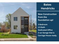 New construction featuring a modern elevation, showcasing a light gray exterior and a well-manicured lawn at 315 E Minnesota St, Indianapolis, IN 46225