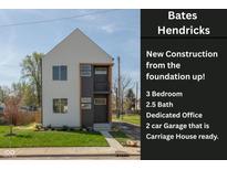 Modern two-story home boasts a sleek design, tidy front yard, and carriage house ready two-car garage at 315 E Minnesota St, Indianapolis, IN 46225