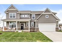 Charming two-story home with gray siding, a manicured lawn, and a welcoming front porch at 474 Pekin Way, Pendleton, IN 46064