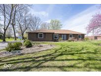 Charming brick home with well-maintained lawn and mature trees at 506 N County Road 900 E, Avon, IN 46123