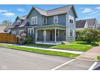 Charming two-story home with a covered porch with simple white pillars and a well-maintained front yard at 516 S 10Th St, Noblesville, IN 46060