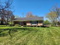 Charming brick ranch-style home featuring a well-manicured lawn and classic architectural details at 5436 David St, Lawrence, IN 46226
