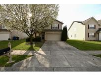 Charming home with a blooming tree in the front yard at 5828 Long Lake Ln, Indianapolis, IN 46235