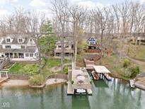 Stunning aerial view of lakefront homes with private docks and boat slips surrounded by mature trees at 6948 Eagle Dr, Nineveh, IN 46164