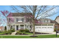 Charming two-story home with a three-car garage and beautifully landscaped front yard at 7613 W Stonegate Dr, Zionsville, IN 46077