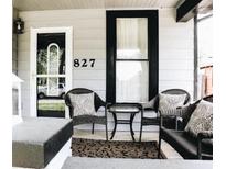 Inviting front porch with seating area, perfect for relaxing and enjoying the neighborhood at 827 Dawson St, Indianapolis, IN 46203