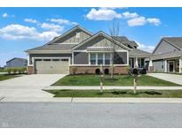 Charming single-Gathering home with a well-manicured lawn, two-car garage, and inviting curb appeal at 8570 Hudson Way, Brownsburg, IN 46112
