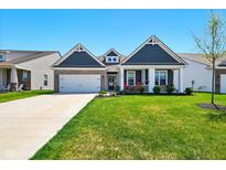Charming home featuring blue siding, brick accents, a well-manicured lawn, and inviting curb appeal at 9847 Bryce Blvd, Pendleton, IN 46064