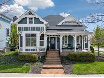 Charming two-story home featuring a cozy front porch, well-maintained landscaping, and a welcoming brick pathway at 2197 Duke Of York St, Carmel, IN 46032