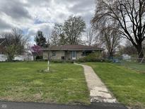 Charming one-story home with a well-manicured front lawn and a welcoming walkway leading to the front door at 3315 Hillcrest Dr, Columbus, IN 47203