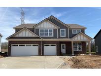 Charming two-story home featuring a brick facade, attached two-car garage and covered entryway at 4235 Brocket Dr, Greenwood, IN 46143