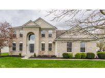 Two-story brick home featuring a manicured lawn and arched entryway with large windows at 559 Hythe Way, Westfield, IN 46074