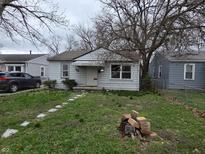 Modest single story home with a small yard and walkway at 5842 Greenfield Ave, Indianapolis, IN 46219