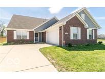 Charming brick home featuring a well-manicured lawn and an inviting front entrance at 6479 Enclave Blvd, Greenwood, IN 46143