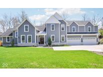 Stunning two-story home with manicured lawn and a three-car garage featuring modern architectural details at 961 Starkey Rd, Zionsville, IN 46077