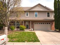 Charming two-story home featuring a manicured lawn and an attached two-car garage at 1401 Runningbrook Ln, Avon, IN 46123