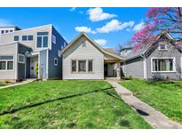 Charming home featuring mature landscaping and a well-maintained lawn, complemented by clear blue skies at 1422 Olive St, Indianapolis, IN 46203
