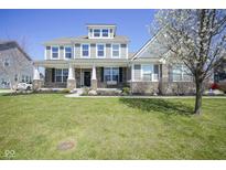 Beautiful two-story home with large front yard, manicured landscaping, and inviting curb appeal at 15594 Garrano Ln, Fishers, IN 46040