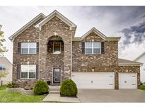 Charming two-story brick home with a three-car garage and well-maintained landscaping at 1583 Valdarno Dr, Greenwood, IN 46143