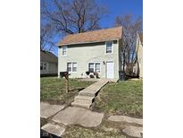 Inviting two-story home with a well-maintained lawn and traditional architectural details at 1708 W 7Th St, Muncie, IN 47302