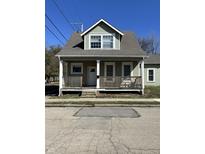 Charming two-story home with a covered front porch and well-maintained exterior at 312 S Gharkey St, Muncie, IN 47305