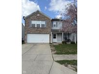 Two-story home featuring brick facade, attached two-car garage, lawn, and covered porch at 350 Springfield Cir, Greenwood, IN 46143