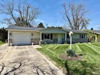 Charming single-story home featuring a well-maintained lawn and attached one car garage at 3601 N Oakwood Ave, Muncie, IN 47304