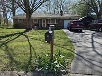 Charming single-story brick home with a well-manicured lawn and mailbox by the driveway at 3614 Thorncrest Dr, Indianapolis, IN 46234