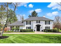 Charming two-story home features a well-manicured lawn, black trim, and an inviting entrance, with a beautiful blue sky at 4339 Royal Pine Blvd, Indianapolis, IN 46250