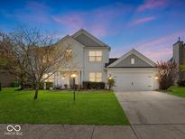 Charming two-story home with a well-manicured lawn, attached two-car garage and inviting curb appeal at 45 Wisteria Way, Westfield, IN 46074