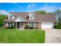 Charming brick home with a well-manicured lawn, attached garage, and inviting front entrance at 4786 N Mill Ct, Greenfield, IN 46140