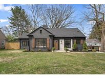 Charming home featuring a brick exterior, stylish shutters, landscaping, and a well-maintained front yard at 5954 Crestview Ave, Indianapolis, IN 46220