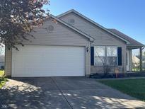 Charming single-story home with an attached two car garage and landscaped front yard at 7675 Mistflower Ln, Noblesville, IN 46062